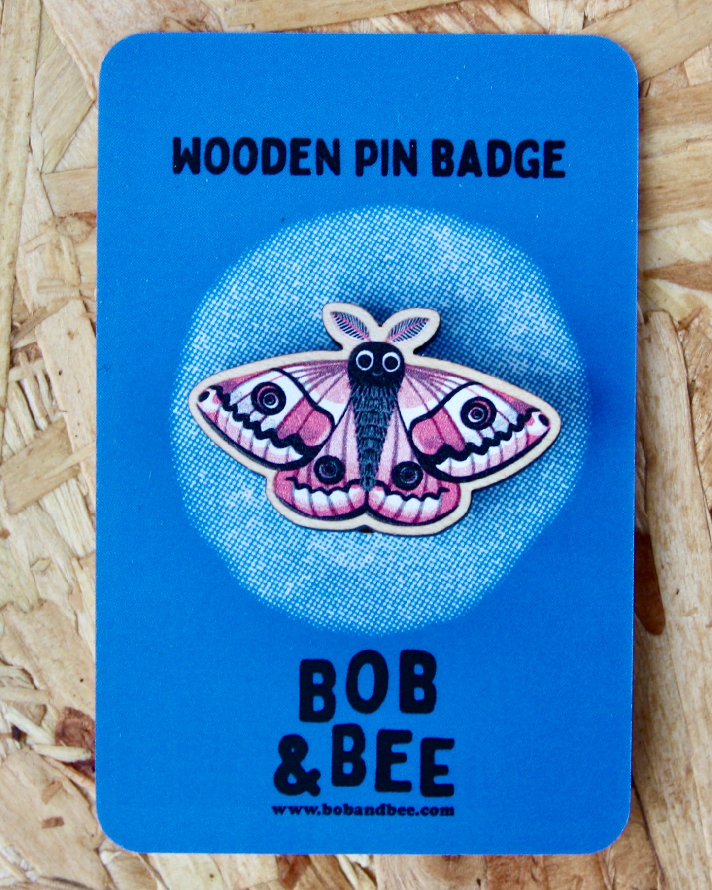 Blue card with an Emperor moth design and 'Bob & Bee' branding on a wooden background