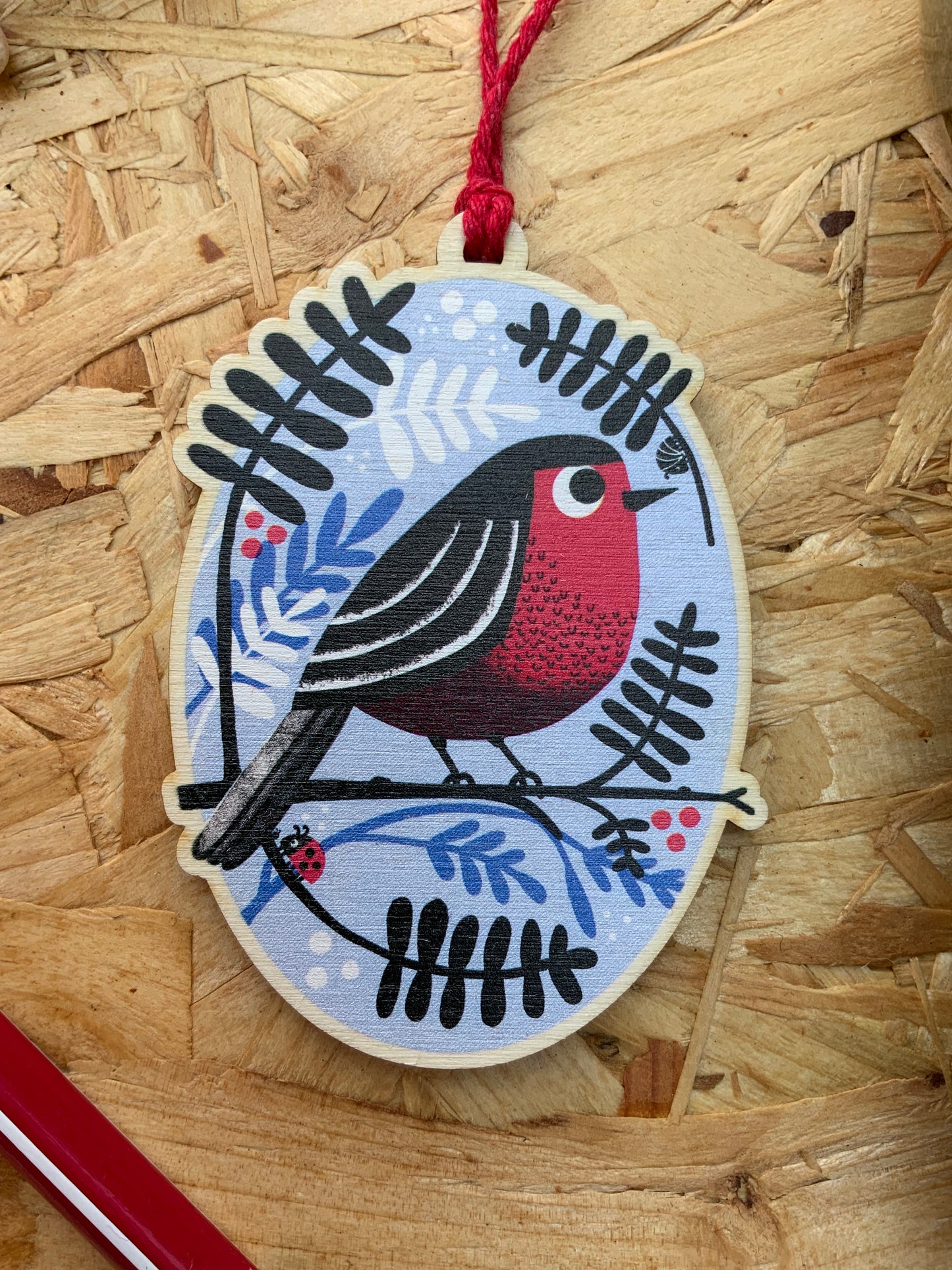 Quirky Robin and Foliage Wooden Christmas Decoration on a wooden background