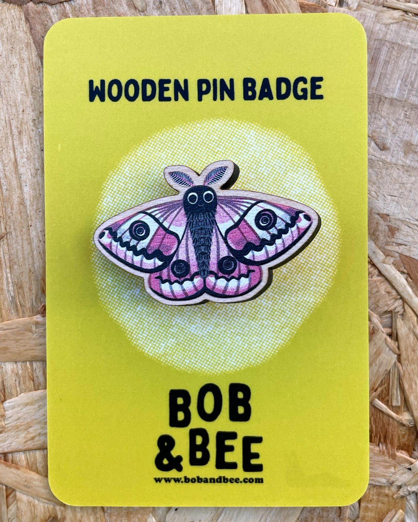 Wooden pin badge with an emperor moth design on a yellow card, branded 'Bob & Bee'.