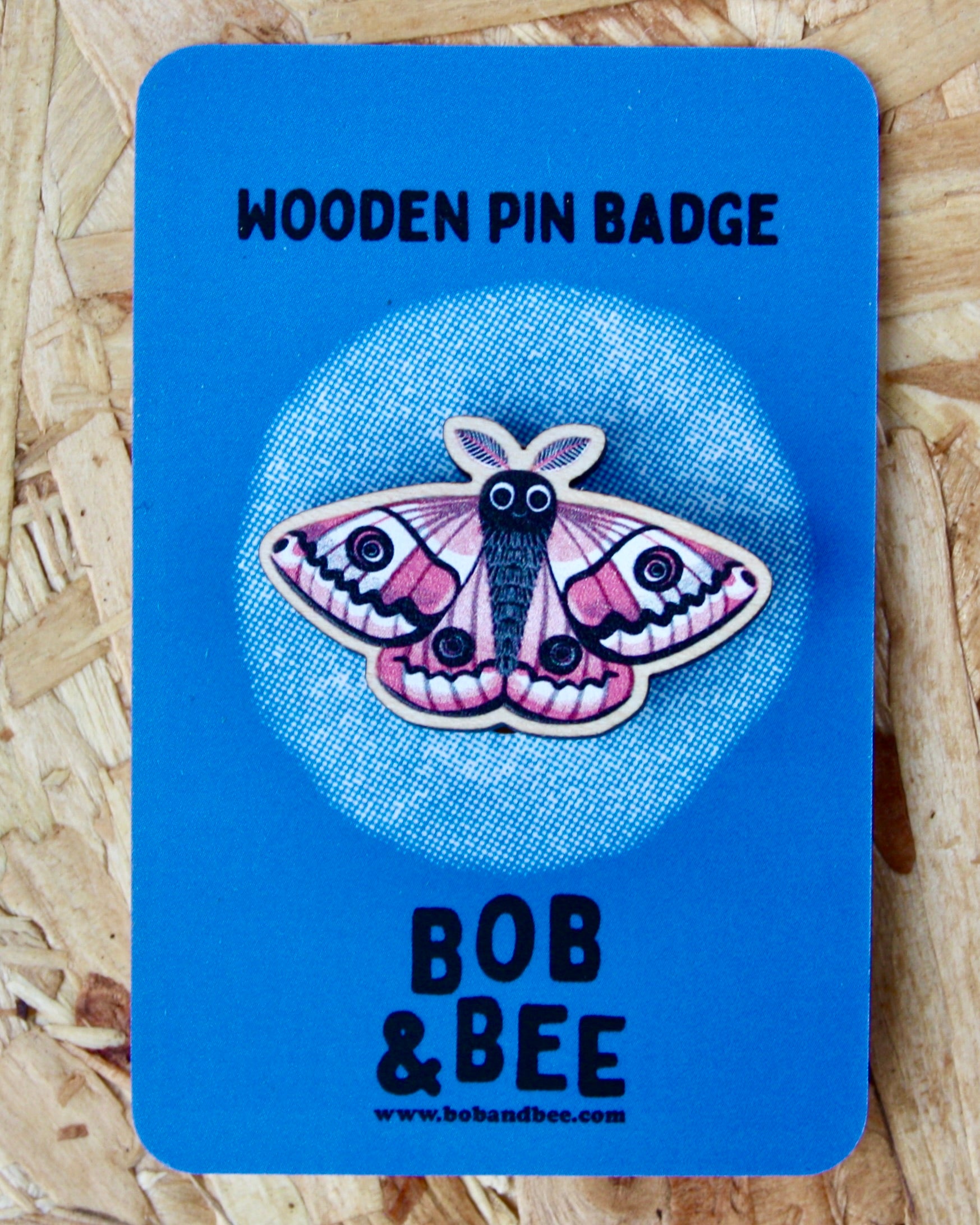 Blue card with an Emperor moth design and 'Bob & Bee' branding on a wooden background
